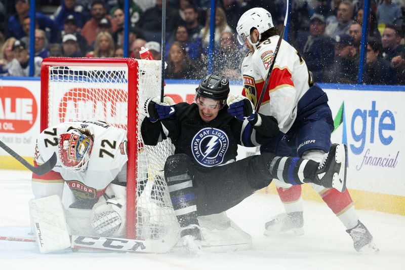 Feb 17, 2024; Tampa, Florida, USA;  Tampa Bay Lightning center Michael Eyssimont (23) is forced into the goal by Florida Panthers defenseman Josh Mahura (28) in the first period  at Amalie Arena. Mandatory Credit: Nathan Ray Seebeck-USA TODAY Sports