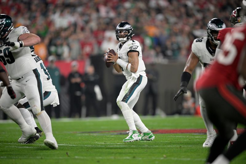 Philadelphia Eagles quarterback Jalen Hurts (1) looks for a receiver during the first half of an NFL wild-card playoff football game against the Tampa Bay Buccaneers, Monday, Jan. 15, 2024, in Tampa, Fla. (AP Photo/Phelan M. Ebenhack)