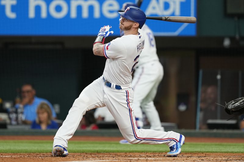 Sep 20, 2023; Arlington, Texas, USA; Texas Rangers catcher Jonah Heim (28) follows through on his three-run home run against the Boston Red Sox during the second inning at Globe Life Field. Mandatory Credit: Jim Cowsert-USA TODAY Sports