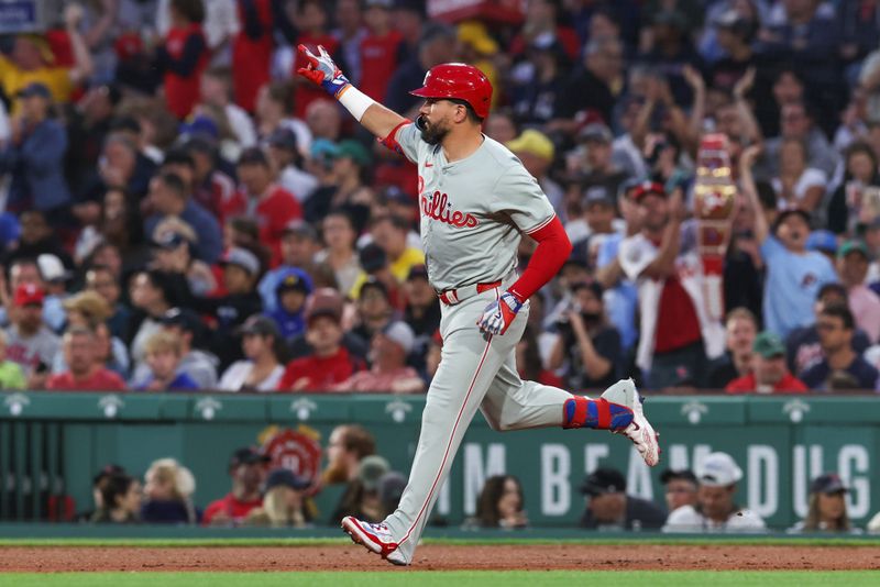 Jun 11, 2024; Boston, Massachusetts, USA; Philadelphia Phillies designated hitter Kyle Schwarber (12) celebrates after hitting a solo home run during the fifth inning against the Boston Red Sox at Fenway Park. Mandatory Credit: Paul Rutherford-USA TODAY Sports