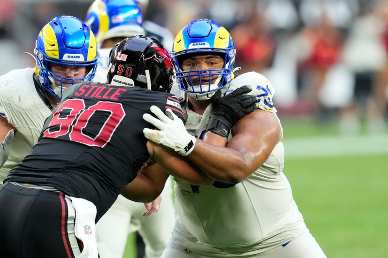 Los Angeles Rams guard Steve Avila, right, blocks Arizona Cardinals defensive end Ben Stille, left, during the second half of an NFL football game Sunday, Nov. 26, 2023, in Glendale, Ariz. The Rams won 37-14. (AP Photo/Ross D. Franklin)