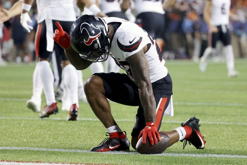 Houston Texans running back Cam Akers (22) reacts after scoring a touchdown during an NFL preseason football game against the Chicago Bears, Thursday Aug. 21, 2024, in Canton, Ohio. (AP Photo/Kirk Irwin)