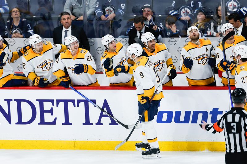 Mar 13, 2024; Winnipeg, Manitoba, CAN; Nashville Predators forward Filip Forsberg (9) is congratulated by his team mates on his goal against the Winnipeg Jets during the third period at Canada Life Centre. Mandatory Credit: Terrence Lee-USA TODAY Sports