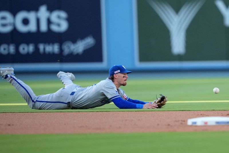 Jun 15, 2024; Los Angeles, California, USA; Kansas City Royals shortstop Bobby Witt Jr. (7) attempts to field the ball against the Los Angeles Dodgers at Dodger Stadium. Mandatory Credit: Kirby Lee-USA TODAY Sports
