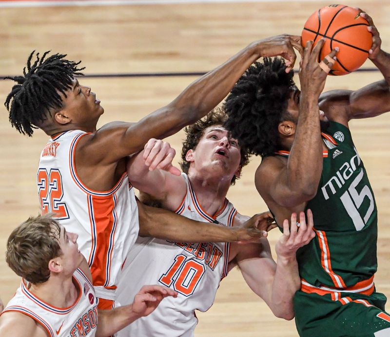 Feb 4, 2023; Clemson, South Carolina, USA; Miami forward Norchad Omier (15) has his shot deflected by Clemson forward RJ Godfrey (22) near Clemson sophomore forward Ben Middlebrooks (10) during the first half at Littlejohn Coliseum in Clemson, S.C. Saturday, Feb. 4, 2023.   Mandatory Credit: Ken Ruinard-USA TODAY Sports