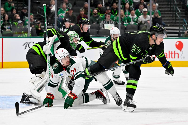 Jan 10, 2024; Dallas, Texas, USA; Minnesota Wild right wing Brandon Duhaime (21) skates between Dallas Stars goaltender Scott Wedgewood (41) and left wing Mason Marchment (27) during the first period at the American Airlines Center. Mandatory Credit: Jerome Miron-USA TODAY Sports