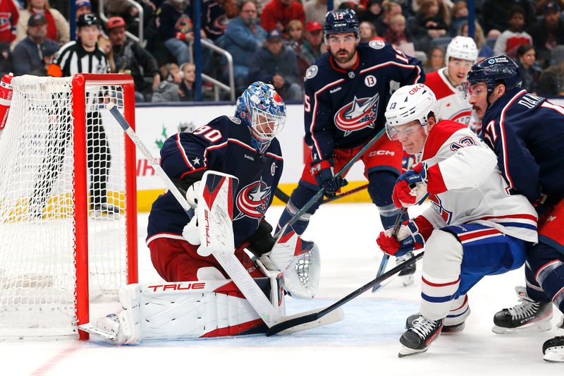 Nov 27, 2024; Columbus, Ohio, USA; Columbus Blue Jackets goalie Elvis Merzlikins (90) makes a save as Montreal Canadiens right wing Cole Caufield (13) looks for a rebound during the third period at Nationwide Arena. Mandatory Credit: Russell LaBounty-Imagn Images
