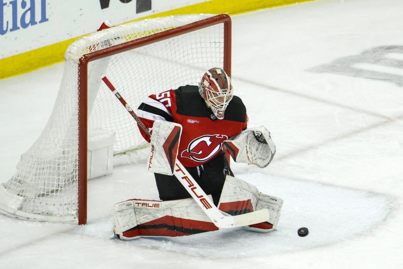 Feb 24, 2024; Newark, New Jersey, USA; New Jersey Devils goaltender Nico Daws (50) makes a save against the Montreal Canadiens during the third period at Prudential Center. Mandatory Credit: John Jones-USA TODAY Sports