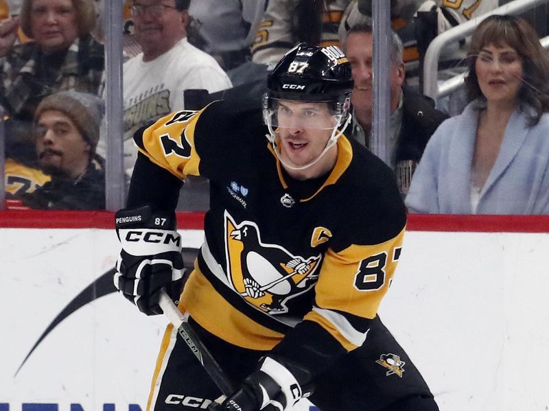 Mar 16, 2024; Pittsburgh, Pennsylvania, USA;  Pittsburgh Penguins center Sidney Crosby (87) handles the puck against the New York Rangers during the second period at PPG Paints Arena. Mandatory Credit: Charles LeClaire-USA TODAY Sports