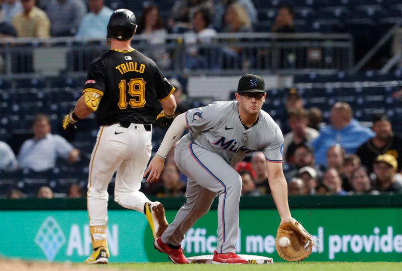 Sep 9, 2024; Pittsburgh, Pennsylvania, USA;  Pittsburgh Pirates third baseman Jared Triolo (19) beats a throw to Miami Marlins first baseman Jonah Bride (41) for an infield single during the fourth inning at PNC Park. Mandatory Credit: Charles LeClaire-Imagn Images