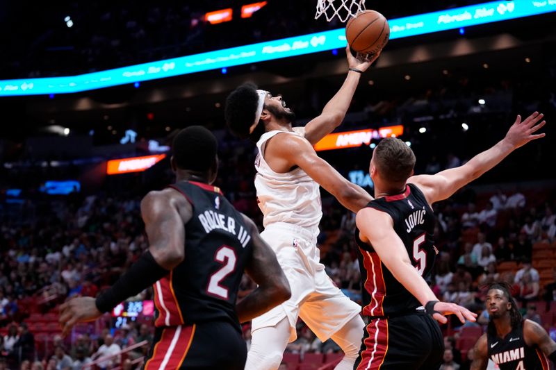 MIAMI, FLORIDA - MARCH 24: Nikola Jovic #5 of the Miami Heat fouls Jarrett Allen #31 of the Cleveland Cavaliers during the first quarter at Kaseya Center on March 24, 2024 in Miami, Florida. NOTE TO USER: User expressly acknowledges and agrees that, by downloading and or using this photograph, User is consenting to the terms and conditions of the Getty Images License Agreement. (Photo by Rich Storry/Getty Images)