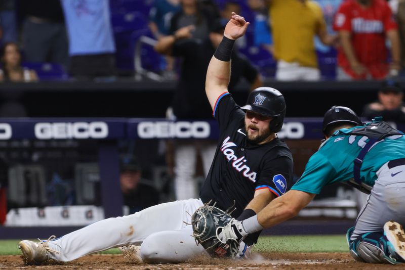 Jun 21, 2024; Miami, Florida, USA; Miami Marlins first baseman Jake Burger (36) scores the game-winning run after an RBI single by shortstop Tim Anderson (not pictured) against the Seattle Mariners during the tenth inning at loanDepot Park. Mandatory Credit: Sam Navarro-USA TODAY Sports