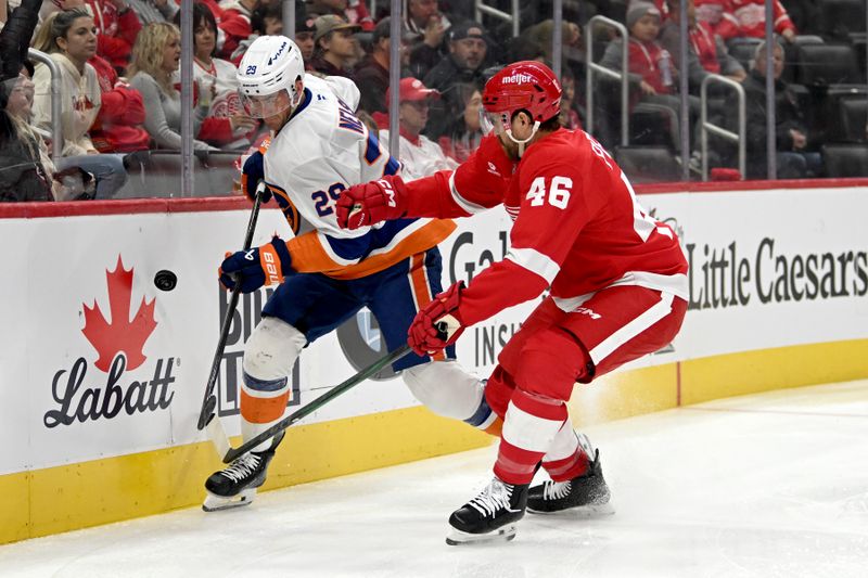 Nov 21, 2024; Detroit, Michigan, USA;  New York Islanders center Brock Nelson (29) battles for the puck along the boards with Detroit Red Wings defenseman Jeff Petry (46) in the first period at Little Caesars Arena. Mandatory Credit: Lon Horwedel-Imagn Images