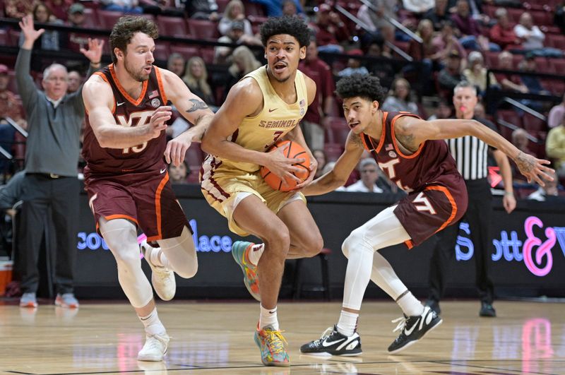 Jan 29, 2025; Tallahassee, Florida, USA; Florida State Seminoles guard Bostyn Holt (3) drives to the net past Virginia Tech Hokies forward Ben Burnham (13) and guard Rodney Brown Jr. (4) during the first half at Donald L. Tucker Center. Mandatory Credit: Melina Myers-Imagn Images