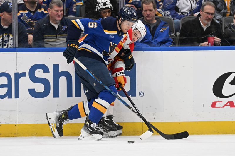 Jan 14, 2025; St. Louis, Missouri, USA; St. Louis Blues defenseman Philip Broberg (6) and Calgary Flames center Rory Kerins (86) battle for the puck in the first period at Enterprise Center. Mandatory Credit: Joe Puetz-Imagn Images