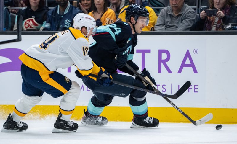 Nov 20, 2024; Seattle, Washington, USA;  Seattle Kraken defenseman Jamie Oleksiak (24) skates against Nashville Predators forward Gustav Nyquist (14) during the second period at Climate Pledge Arena. Mandatory Credit: Stephen Brashear-Imagn Images