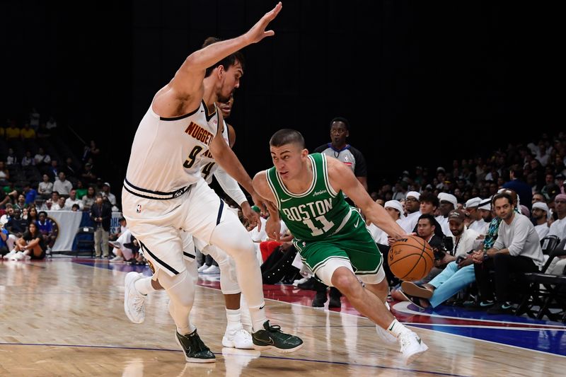 ABU DHABI, UAE - OCTOBER 4: Payton Pritchard #11 of the Boston Celtics dribbles the ball during the game against the Denver Nuggets during the 2024 Global Games on October 4, 2024 at the Etihad Arena in Abu Dhabi, United Arab Emirates. NOTE TO USER: User expressly acknowledges and agrees that, by downloading and/or using this Photograph, user is consenting to the terms and conditions of the Getty Images License Agreement. Mandatory Copyright Notice: Copyright 2024 NBAE (Photo by Brian Babineau/NBAE via Getty Images)