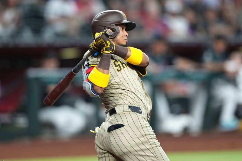 May 4, 2024; Phoenix, Arizona, USA; San Diego Padres designated hitter Luis Arraez (4) hits a double against the Arizona Diamondbacks during the first inning at Chase Field. Mandatory Credit: Joe Camporeale-USA TODAY Sports