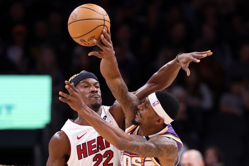 PHOENIX, ARIZONA - NOVEMBER 06: Bradley Beal #3 of the Phoenix Suns passes under pressure from Jimmy Butler #22 of the Miami Heat during the first half at Footprint Center on November 06, 2024 in Phoenix, Arizona. NOTE TO USER: User expressly acknowledges and agrees that, by downloading and or using this photograph, User is consenting to the terms and conditions of the Getty Images License Agreement.  (Photo by Chris Coduto/Getty Images)