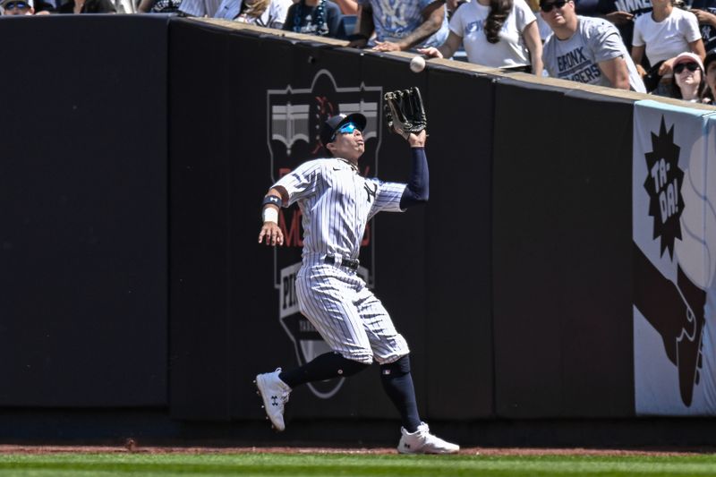 May 27, 2023; Bronx, New York, USA; New York Yankees left fielder Oswaldo Cabrera (95) catches a fly ball against the San Diego Padres during the seventh inning at Yankee Stadium. Mandatory Credit: John Jones-USA TODAY Sports