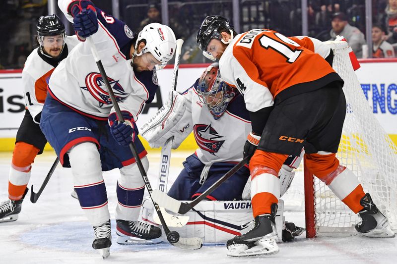 Jan 4, 2024; Philadelphia, Pennsylvania, USA; Columbus Blue Jackets defenseman Ivan Provorov (9) and goaltender Daniil Tarasov (40) battle for the puck with Philadelphia Flyers center Sean Couturier (14) during the third period at Wells Fargo Center. Mandatory Credit: Eric Hartline-USA TODAY Sports