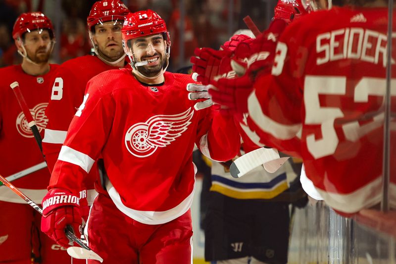 Feb 24, 2024; Detroit, Michigan, USA;  Detroit Red Wings center Robby Fabbri (14) receives congratulations from teammates after scoring in the first period against the St. Louis Blues at Little Caesars Arena. Mandatory Credit: Rick Osentoski-USA TODAY Sports