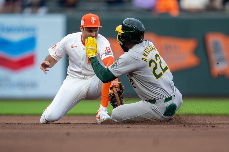 Jul 30, 2024; San Francisco, California, USA;  Oakland Athletics left fielder Miguel Andujar (22) is caught stealing second base by San Francisco Giants second baseman Casey Schmitt (10) during the first inning at Oracle Park. Mandatory Credit: Neville E. Guard-USA TODAY Sports