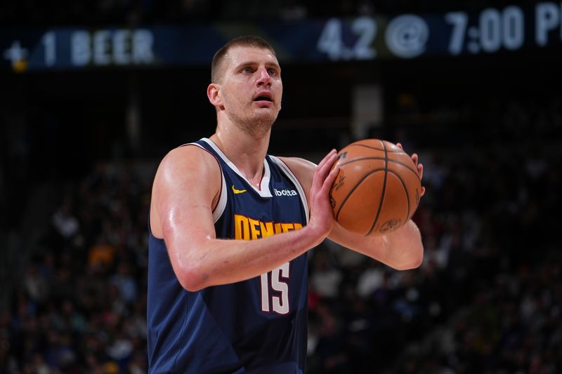 DENVER, CO - MARCH 25: Nikola Jokic #15 of the Denver Nuggets shoots a free throw during the game against the Memphis Grizzlies on March 25, 2024 at the Ball Arena in Denver, Colorado. NOTE TO USER: User expressly acknowledges and agrees that, by downloading and/or using this Photograph, user is consenting to the terms and conditions of the Getty Images License Agreement. Mandatory Copyright Notice: Copyright 2024 NBAE (Photo by Bart Young/NBAE via Getty Images)