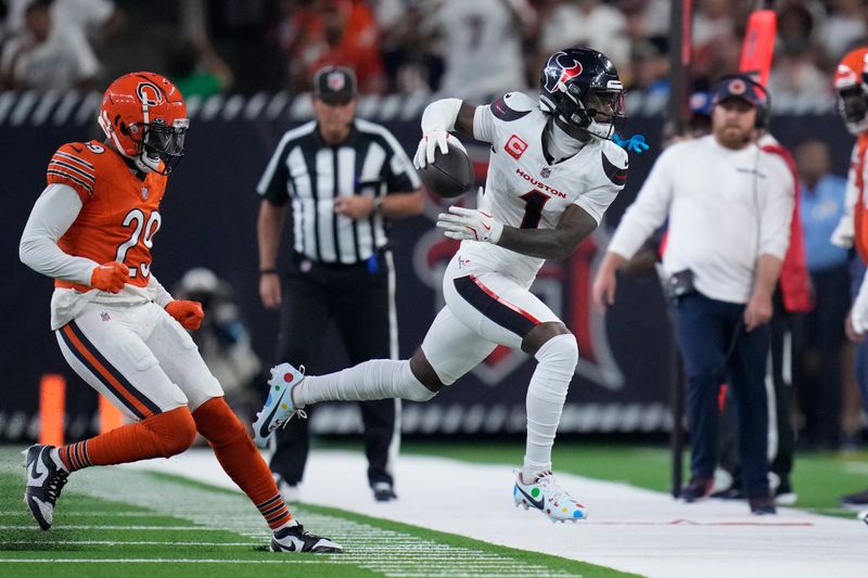 Houston Texans wide receiver Stefon Diggs, right, catches a pass for a first down as Chicago Bears defensive back Tyrique Stevenson (29) defends during the first half of an NFL football game Sunday, Sept. 15, 2024, in Houston. (AP Photo/Eric Gay)