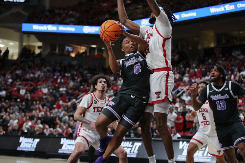 Jan 13, 2024; Lubbock, Texas, USA;  Kansas State Wildcats guard Tylor Perry (2) goes to the hoop against Texas Tech Red Raiders forward Warren Washington (22) in the second half at United Supermarkets Arena. Mandatory Credit: Michael C. Johnson-USA TODAY Sports