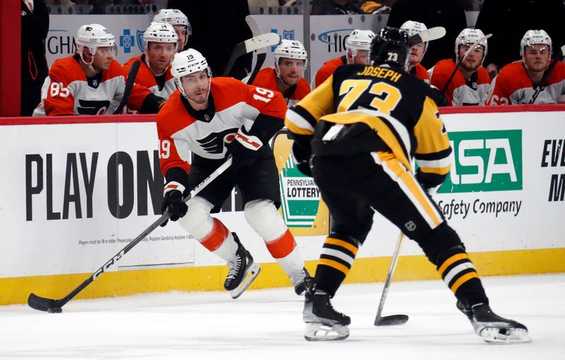 Feb 25, 2024; Pittsburgh, Pennsylvania, USA;  Philadelphia Flyers right wing Garnet Hathaway (19) skates with the puck against Pittsburgh Penguins defenseman Pierre-Olivier Joseph (73) during the first period at PPG Paints Arena. Mandatory Credit: Charles LeClaire-USA TODAY Sports