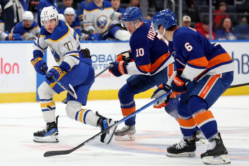 Nov 30, 2024; Elmont, New York, USA; Buffalo Sabres right wing JJ Peterka (77) plays the puck against New York Islanders right wing Simon Holmstrom (10) and defenseman Ryan Pulock (6) during the first period at UBS Arena. Mandatory Credit: Brad Penner-Imagn Images