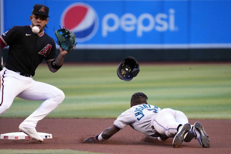 May 9, 2023; Phoenix, Arizona, USA; Miami Marlins center fielder Jazz Chisholm Jr. (2) steals second base ahead of a throw to Arizona Diamondbacks second baseman Ketel Marte (4) during the first inning at Chase Field. Mandatory Credit: Joe Camporeale-USA TODAY Sports