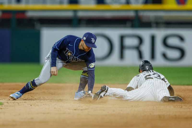 Apr 28, 2023; Chicago, Illinois, USA; Chicago White Sox left fielder Andrew Benintendi (23) steals second base against Tampa Bay Rays second baseman Brandon Lowe (8) during the seventh inning at Guaranteed Rate Field. Mandatory Credit: Kamil Krzaczynski-USA TODAY Sports