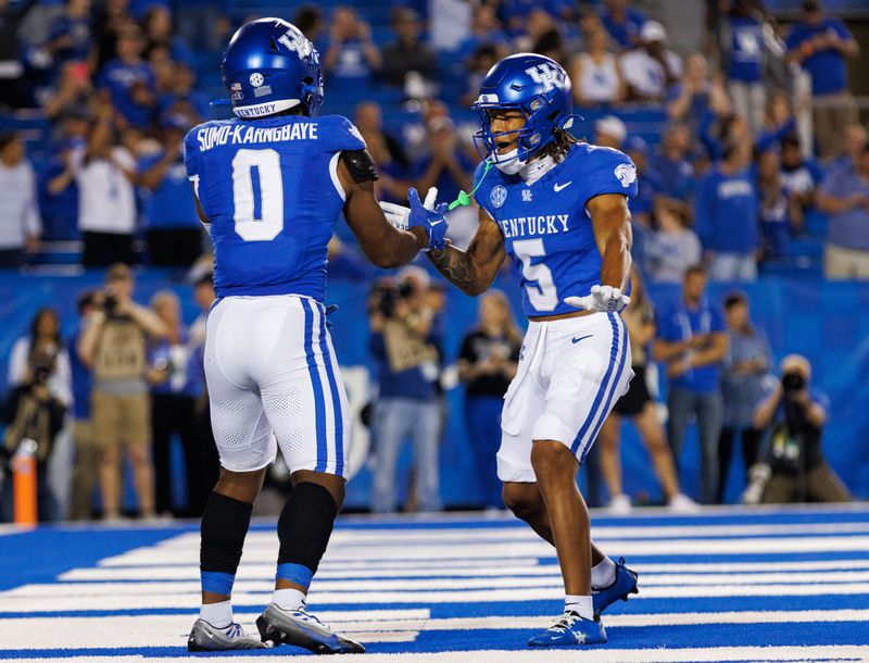 Sep 16, 2023; Lexington, Kentucky, USA; Kentucky Wildcats running back Demie Sumo-Karngbaye (0) celebrates a touchdown with wide receiver Anthony Brown-Stephens (5) during the fourth quarter against the Akron Zips at Kroger Field. Mandatory Credit: Jordan Prather-USA TODAY Sports