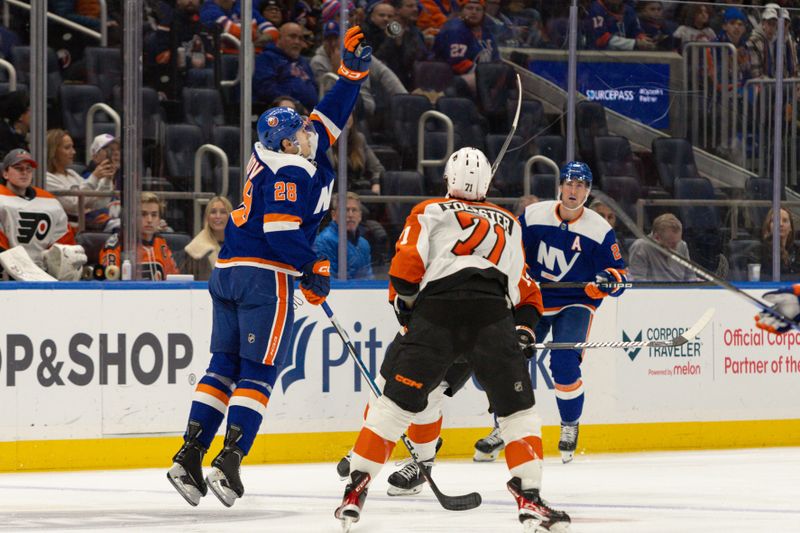 Nov 25, 2023; Elmont, New York, USA; New York Islanders defenseman Alexander Romanov (28) leaps to keep the puck on side against the Philadelphia Flyers during the first period at UBS Arena. Mandatory Credit: Thomas Salus-USA TODAY Sports