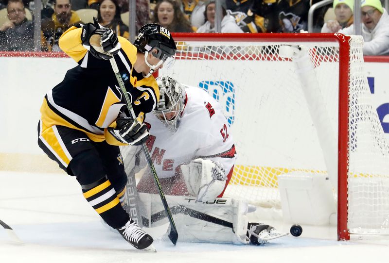 Nov 29, 2022; Pittsburgh, Pennsylvania, USA; Pittsburgh Penguins center Sidney Crosby (87) scores a goal against Carolina Hurricanes goaltender Pyotr Kochetkov (52) during the first period at PPG Paints Arena. Mandatory Credit: Charles LeClaire-USA TODAY Sports