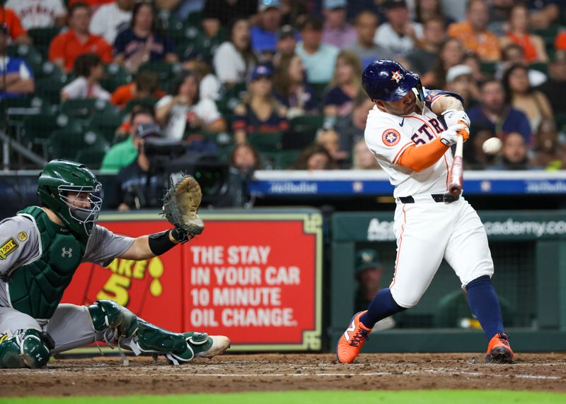 May 27, 2025; Houston, Texas, USA; Houston Astros designated hitter Jose Altuve (27) hits a home run against the Athletics in the fourth inning at Daikin Park. Mandatory Credit: Thomas Shea-Imagn Images
