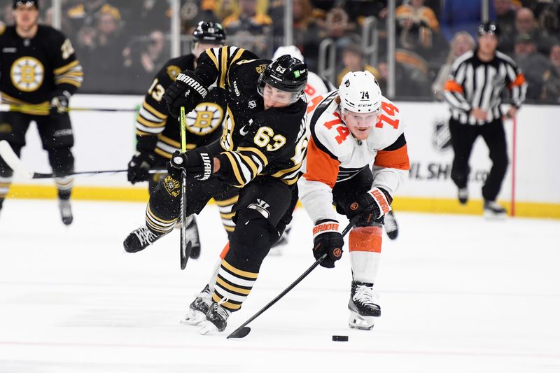 Mar 16, 2024; Boston, Massachusetts, USA; Philadelphia Flyers right wing Owen Tippett (74) steals the puck from Boston Bruins left wing Brad Marchand (63) during the third period at TD Garden. Mandatory Credit: Bob DeChiara-USA TODAY Sports