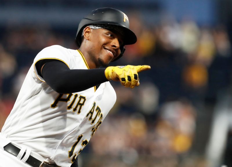 Sep 4, 2023; Pittsburgh, Pennsylvania, USA;  Pittsburgh Pirates third baseman Ke'Bryan Hayes (13) gestures to the dugout as he circles the bases on a solo home run against the Milwaukee Brewers during the fifth inning at PNC Park. Mandatory Credit: Charles LeClaire-USA TODAY Sports