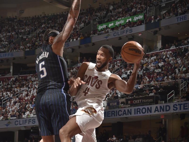 CLEVELAND, OH - APRIL 22: Evan Mobley #4 of the Cleveland Cavaliers passes the ball during the game against the Orlando Magic during Round 1 Game 2 of the 2024 NBA Playoffs on April 22, 2024 at Rocket Mortgage FieldHouse in Cleveland, Ohio. NOTE TO USER: User expressly acknowledges and agrees that, by downloading and/or using this Photograph, user is consenting to the terms and conditions of the Getty Images License Agreement. Mandatory Copyright Notice: Copyright 2024 NBAE (Photo by David Liam Kyle/NBAE via Getty Images)