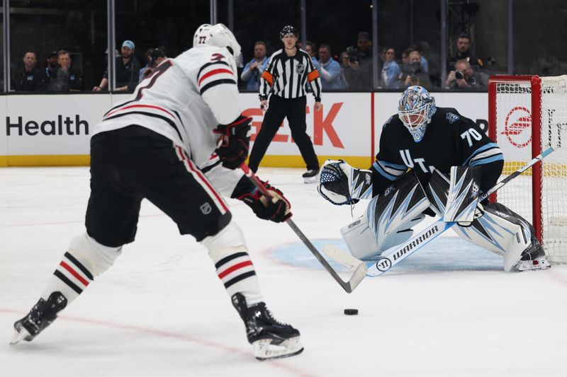 Feb 25, 2025; Salt Lake City, Utah, USA; Utah Hockey Club goaltender Karel Vejmelka (70) defends the net against Chicago Blackhawks left wing Patrick Maroon (77) during the second period at Delta Center. Mandatory Credit: Rob Gray-Imagn Images