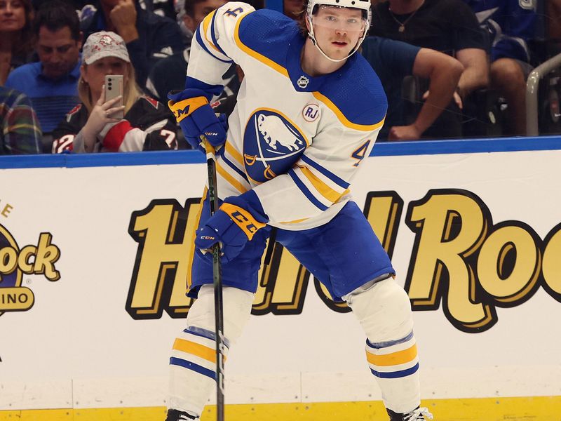 Apr 15, 2024; Tampa, Florida, USA;  Buffalo Sabres defenseman Bowen Byram (4) passes the puck against the Tampa Bay Lightning during the second period at Amalie Arena. Mandatory Credit: Kim Klement Neitzel-USA TODAY Sports