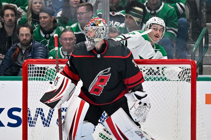 Jan 25, 2023; Dallas, Texas, USA; Dallas Stars left wing Mason Marchment (27) appears to strike the back of the neck of Carolina Hurricanes goaltender Antti Raanta (32) with his stick as Marchment skates by during the third period at the American Airlines Center. Mandatory Credit: Jerome Miron-USA TODAY Sports