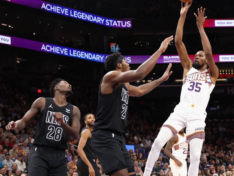 PHOENIX, ARIZONA - DECEMBER 13: Kevin Durant #35 of the Phoenix Suns attempts a shot over Day'Ron Sharpe #20 of the Brooklyn Nets during the first half of the NBA game at Footprint Center on December 13, 2023 in Phoenix, Arizona. NOTE TO USER: User expressly acknowledges and agrees that, by downloading and or using this photograph, User is consenting to the terms and conditions of the Getty Images License Agreement.  (Photo by Christian Petersen/Getty Images)