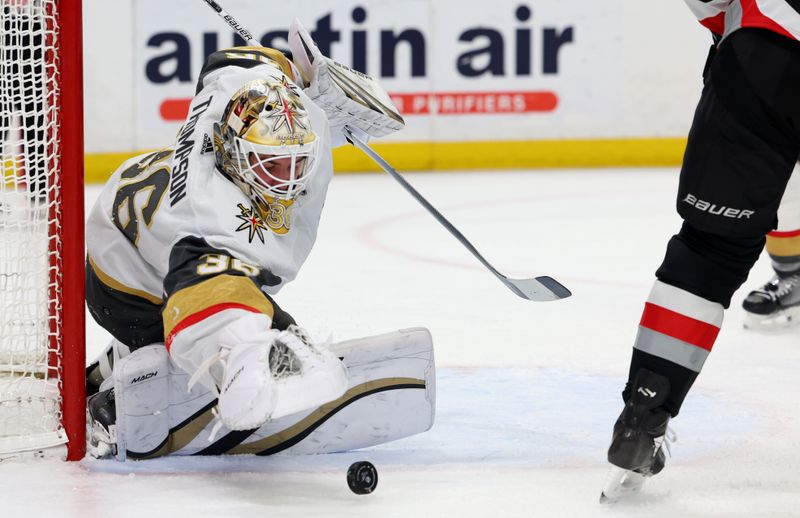 Mar 2, 2024; Buffalo, New York, USA;  Vegas Golden Knights goaltender Logan Thompson (36) looks to cover up the puck during the second period against the Buffalo Sabres at KeyBank Center. Mandatory Credit: Timothy T. Ludwig-USA TODAY Sports