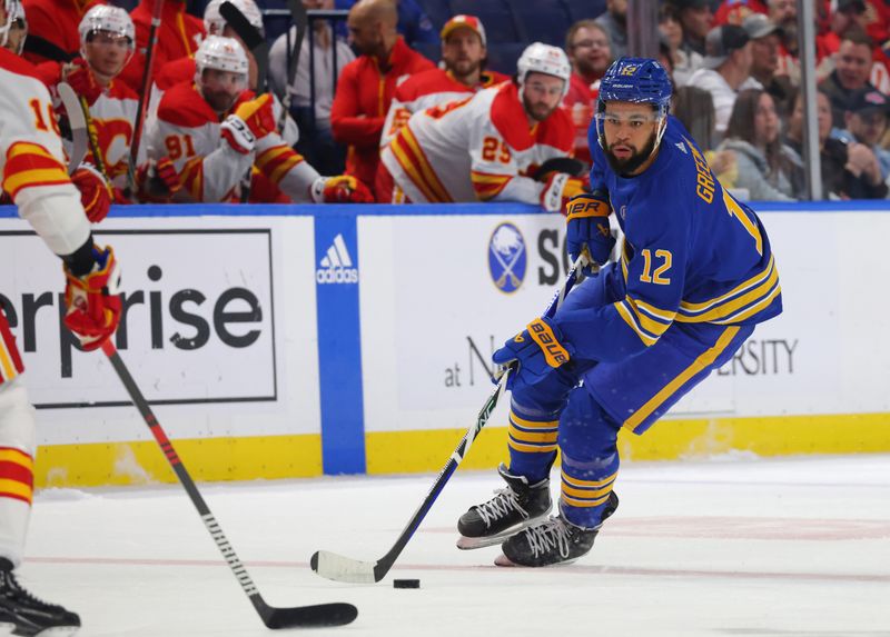 Oct 19, 2023; Buffalo, New York, USA;  Buffalo Sabres left wing Jordan Greenway (12) skates up ice with the puck during the second period against the Calgary Flames at KeyBank Center. Mandatory Credit: Timothy T. Ludwig-USA TODAY Sports