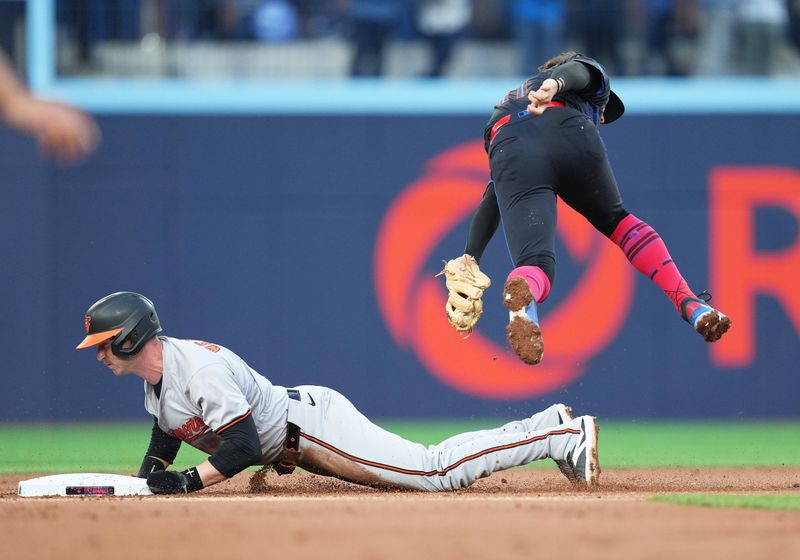 Jun 3, 2024; Toronto, Ontario, CAN; Baltimore Orioles third baseman Jordan Westburg (11) steals second base ahead of the tag from Toronto Blue Jays shortstop Bo Bichette (11) during the second  inning at Rogers Centre. Mandatory Credit: Nick Turchiaro-USA TODAY Sports