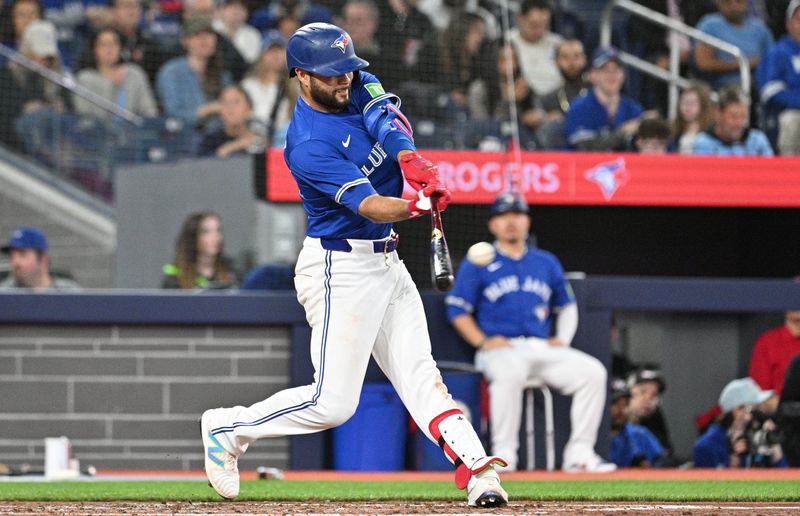 Apr 13, 2024; Toronto, Ontario, CAN;  Toronto Blue Jays third baseman Isiah Kiner-Falefa (7) hits a single against the Colorado Rockies in the fourth inning at Rogers Centre. Mandatory Credit: Dan Hamilton-USA TODAY Sports