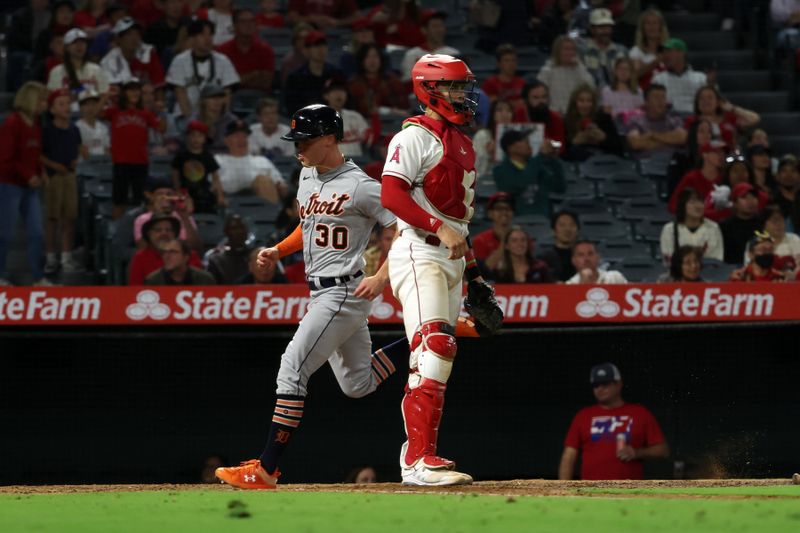 Sep 16, 2023; Anaheim, California, USA;  Detroit Tigers right fielder Kerry Carpenter (30) scores a run on an RBI single by designated hitter Miguel Cabrera (24) as Los Angeles Angels catcher Logan O'Hoppe (14) watches a play during the tenth inning at Angel Stadium. Mandatory Credit: Kiyoshi Mio-USA TODAY Sports